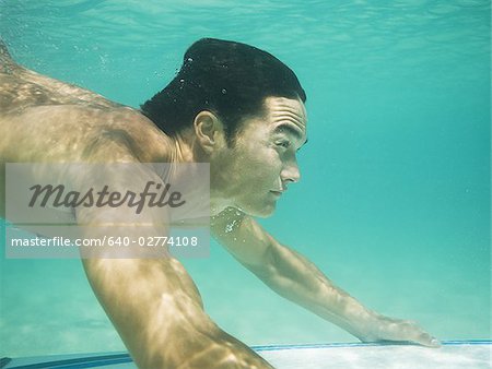 Man underwater water with surfboard