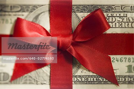 One hundred US dollar banknote with red ribbon