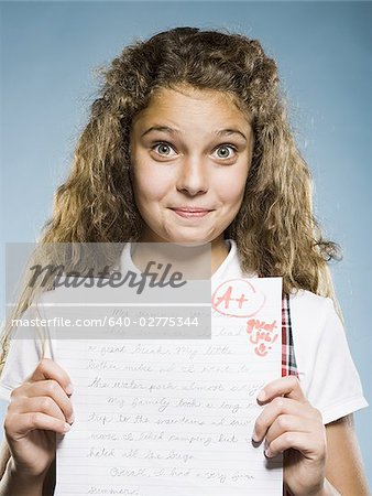 Girl holding A plus paper smiling
