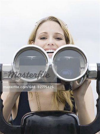 Woman with coin operated binoculars smiling