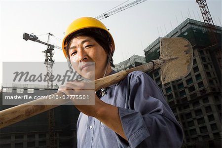 Construction worker outdoors with helmet smiling