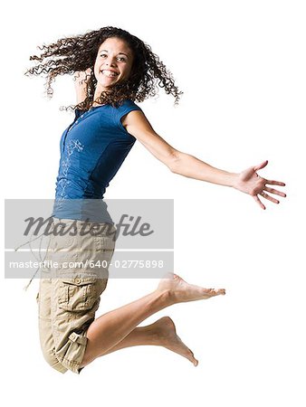 Teenage girl leaping and smiling