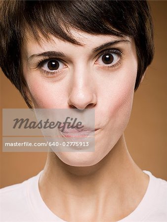 Woman making funny face with eyes crossed and puckered lips