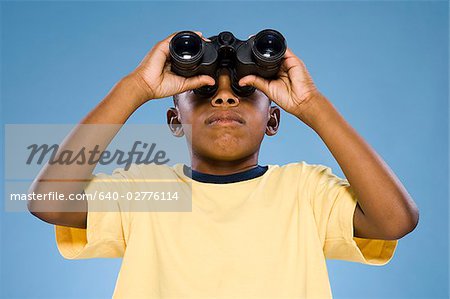 Child looking through binoculars.