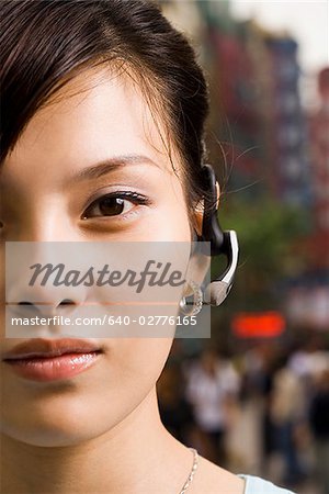 Woman with a cell phone earpiece.