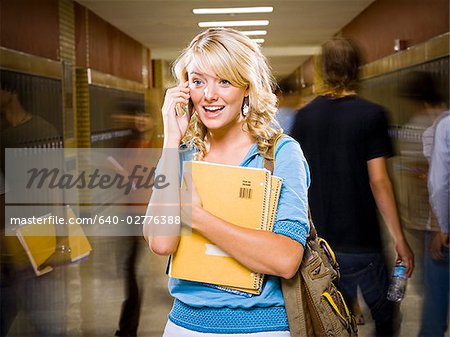High School girl at school on mobile phone.