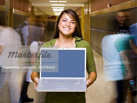 High School girl at school with a notebook computer.