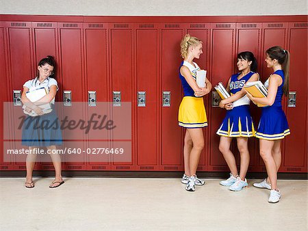 Three High School cheer leaders and a nerd.