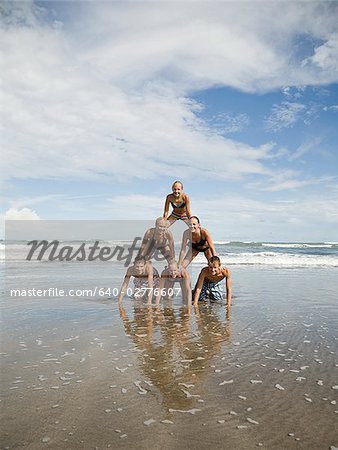 Human pyramid on the beach.