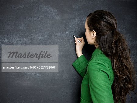 young woman writing on a chalkboard
