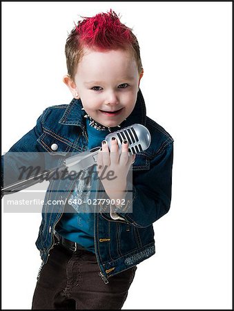 little boy singing into a microphone