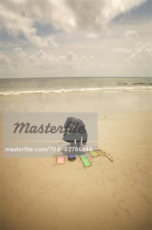 Businessman Drawing Chart in the Sand on the Beach, Savannah, Georgia, USA