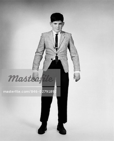 1950s 1960s OVERGROWN BOY IN TOO TIGHT SPORTS JACKET AND PANTS LOOKING AT CAMERA