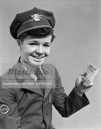 1920s 1930s 1940s SMILING BOY WEARING A WESTERN UNION UNIFORM AND HAT HOLDING A TELEGRAM RETRO COMMUNICATION