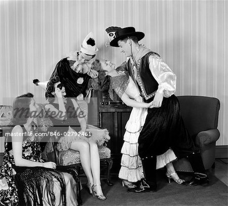 1930s COUPLES DRESSED IN COSTUMES DANCING & PARTYING AT HOME