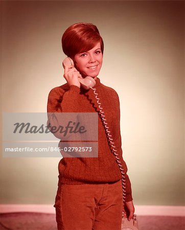 1960s WOMAN TALKING ON TELEPHONE LOOKING AT CAMERA