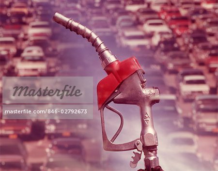 1960s NOZZLE OF GASOLINE PUMP WITH TRAFFIC BACKGROUND