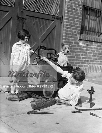 1930s TWO CHILDREN BOY GIRL AND DOG FIXING TOY AUTOMOBILE