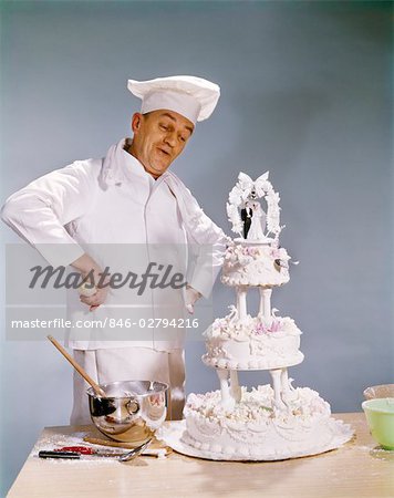 CHEF LOOKING AT WEDDING CAKE