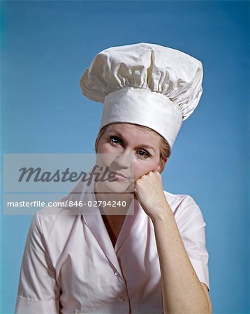 1960s WOMAN CHEF WEAR TOQUE HAT LEANING FACE ON FIST LOOKING SAD SERIOUS FAILURE DEPRESSED