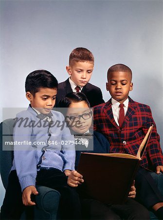 1960s PORTRAIT OF FOUR BOYS ETHNIC MIX AFRICAN AMERICAN WHITE ASIAN HISPANIC WEARING SUITS READING BOOK