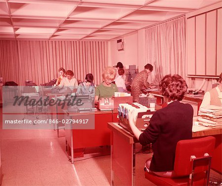 1960s MANY WOMEN IN OPEN OFFICE WORKING WITH TYPEWRITERS CARD FILES AND ROLODEX