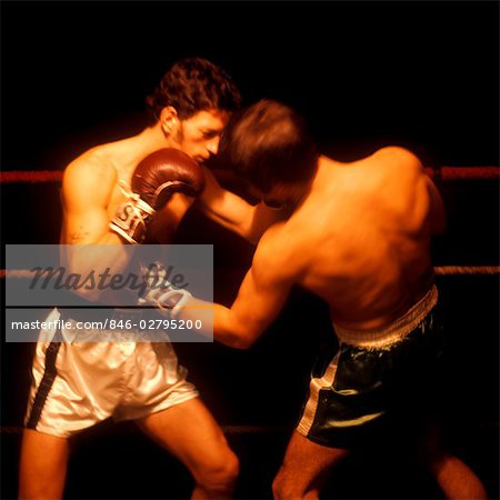 1960s TWO MEN BOXING ONE FACE CAMERA WHITE TRUNKS GLOVES ROPES RING PUNCH PUNCHING FIGHT PUGILIST FIGHTER