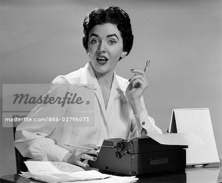 1950s WOMAN DESK SECRETARY TYPEWRITER FINGER IDEA TALK