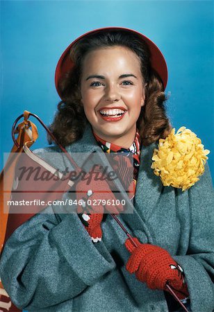 1940s 1950s SMILING YOUNG WOMAN WITH COLLEGE PENNANT HOMECOMING CORSAGE MUM WEARING GRAY COAT & RED GLOVES