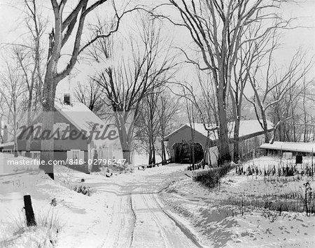 1950s WINTER ROAD LEADING TO COVERED BRIDGE AND HOUSE COLD SNOWY RURAL LANDSCAPE