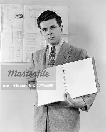 1940s BUSINESS MAN HOLDING NOTEBOOK AND PENCIL PRESENTATION