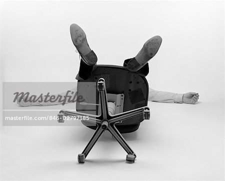 1980s MAN ONLY SEE ARMS LEGS BOTTOM OF OFFICE CHAIR FALLEN OVER BACKWARDS