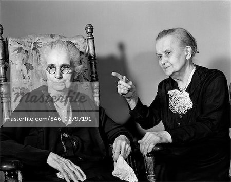 1940s 1950s TWO ELDERLY SENIOR WOMAN TALKING ONE POINTING