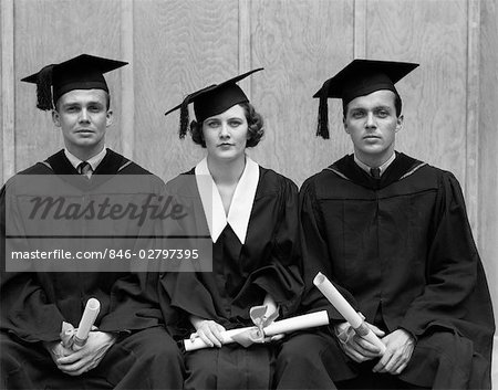 1930s 1940s THREE UNIVERSITY STUDENTS CAP GOWN GRADUATION ROBES 2 MEN WOMAN STUDENTS HOLDING DIPLOMAS