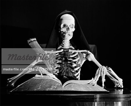 STILL LIFE OF SKELETON WRITING IN LARGE BOOK WITH QUILL PEN