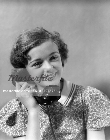 1930s TEEN GIRL SMILING BRUNETTE PRINT DRESS TALKING ON TELEPHONE