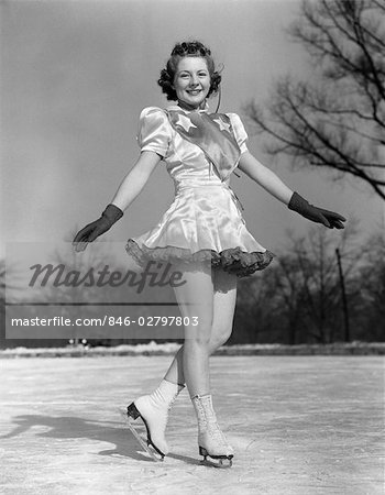 1930s WOMAN FIGURE SKATER ON ICE WEARING DRESS AND GLOVES