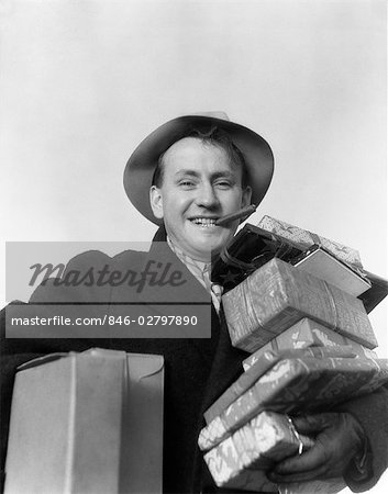 1930s MAN CIGAR IN MOUTH HAT CARRYING WRAPPED PRESENTS