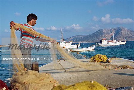 Fisherman sorting his nets, harbour of island of Koufounissia, Lesser Cyclades, Greek Islands, Greece, Europe