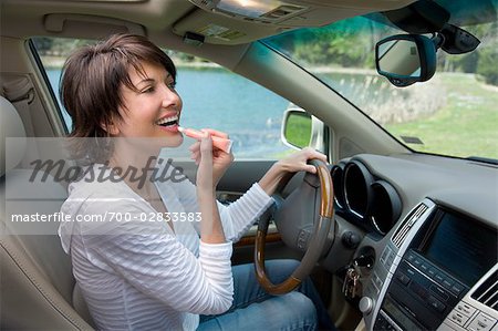 Driver Putting on Lip Gloss