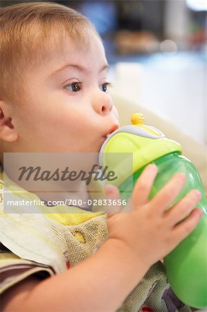 Close-up of Boy with Down Syndrome Drinking from Bottle