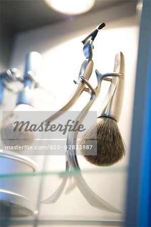 Close-up of Men's Razor and Shaving Brush on Stand