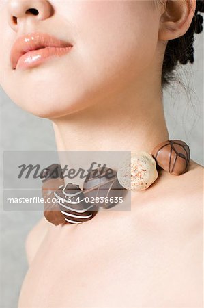 Woman with necklace of chocolates