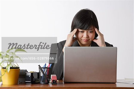 business woman looking stressed at computer
