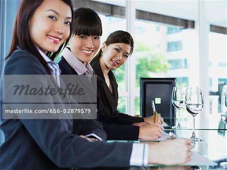 three business woman looking at camera