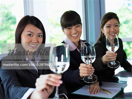 Three woman toasting the camera