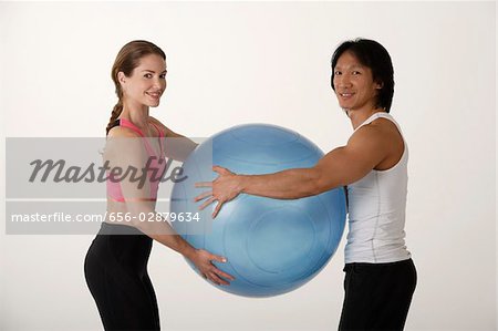 Couple working out with exercise ball