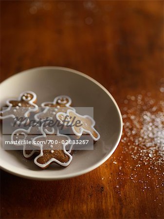Mini Gingerbread Men in a Bowl and Sugar Sprinkled on Table
