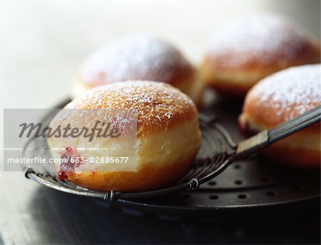 Jam filled donut dusted with powdered sugar
