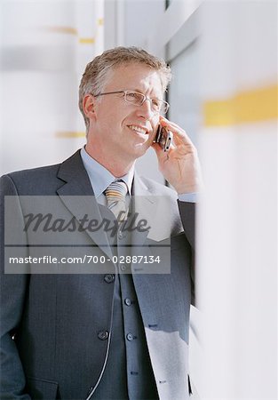 Businessman using Cell Phone at Airport